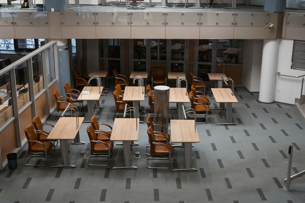 A bright, contemporary office interior with neatly arranged chairs and tables, well suited to workspaces.